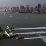 Michael Goulian of USA, Matthias Dolderer of Germany and Kirby Chambliss of USA fly past the Manhattan Skyline and the Statue of Liberty during the Red Bull Air Race New York Calibration Day.